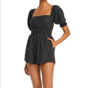 We wore what black and white polka dot romper with puff sleeve